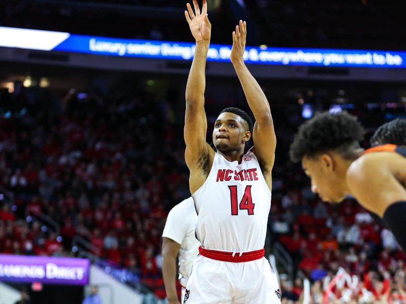 Jan 14, 2023; Raleigh, North Carolina, USA; North Carolina State Wolfpack guard Casey Morsell (14) shoots a free throw during the first half against Miami Hurricanes at PNC Arena. Mandatory Credit: Jaylynn Nash-USA TODAY Sports