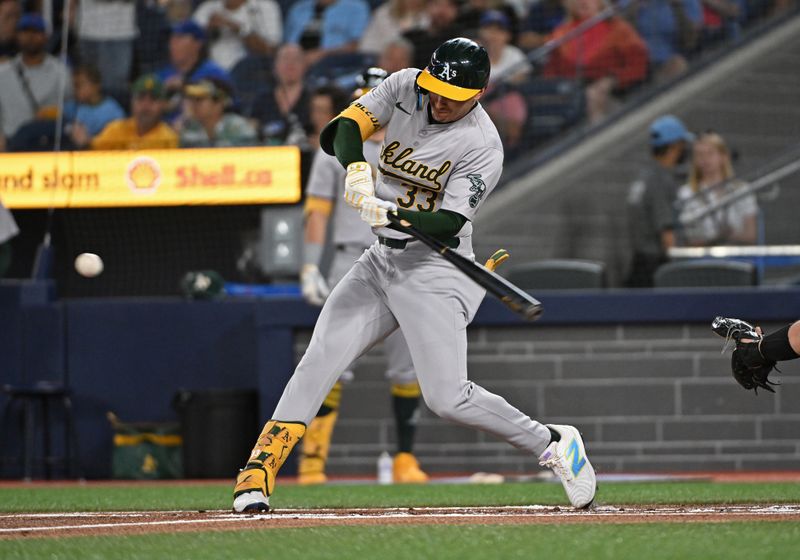Aug 11, 2024; Toronto, Ontario, CAN; Oakland Athletics centre field JJ Bleday (33) hits a two run home run in the first inning against the Toronto Blue Jays at Rogers Centre. Mandatory Credit: Gerry Angus-USA TODAY Sports