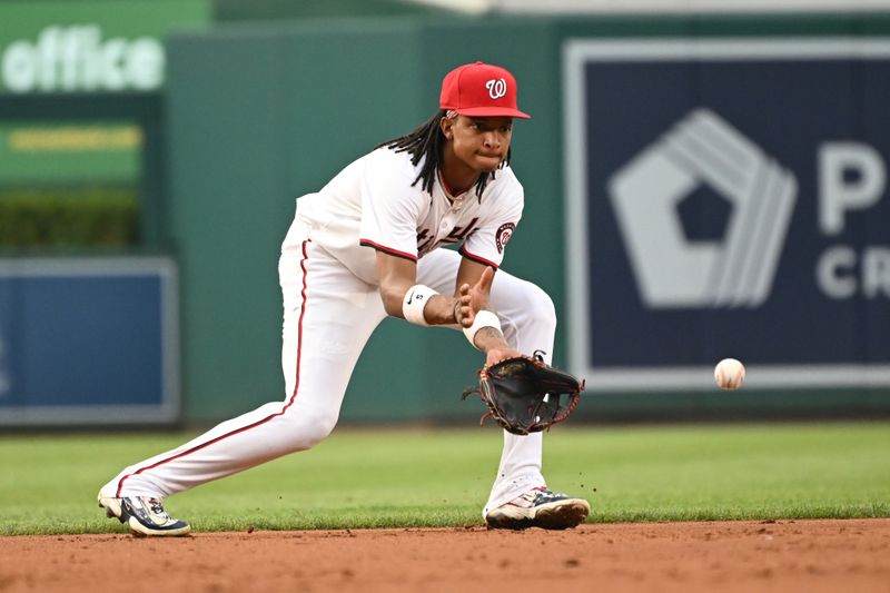 Aug 6, 2024; Washington, District of Columbia, USA; Washington Nationals shortstop CJ Abrams (5) fields a ground ball against the San Francisco Giants during the second inning at Nationals Park. Mandatory Credit: Rafael Suanes-USA TODAY Sports