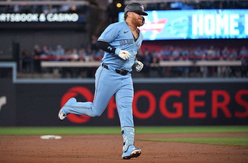 Apr 29, 2024; Toronto, Ontario, CAN;  Toronto Blue Jays designated hitter Justin Turner (2) rounds the bases after hitting a two run home run against the Kansas City Royals in the first inning at Rogers Centre. Mandatory Credit: Dan Hamilton-USA TODAY Sports