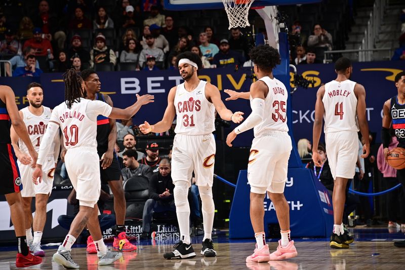 DETROIT, MI - MARCH 1: Jarrett Allen #31 of the Cleveland Cavaliers high fives Darius Garland #10 and Isaac Okoro #35 during the game against the Detroit Pistons on March 1, 2024 at Little Caesars Arena in Detroit, Michigan. NOTE TO USER: User expressly acknowledges and agrees that, by downloading and/or using this photograph, User is consenting to the terms and conditions of the Getty Images License Agreement. Mandatory Copyright Notice: Copyright 2024 NBAE (Photo by Chris Schwegler/NBAE via Getty Images)
