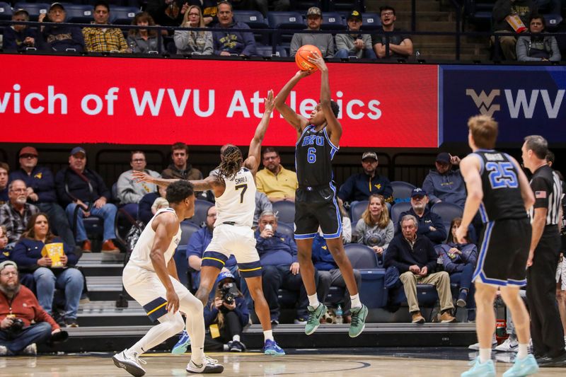 Feb 11, 2025; Morgantown, West Virginia, USA; Brigham Young Cougars forward Kanon Catchings (6) shoots a three pointer over West Virginia Mountaineers guard Javon Small (7) during the first half at WVU Coliseum. Mandatory Credit: Ben Queen-Imagn Images