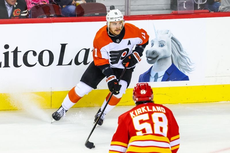 Oct 12, 2024; Calgary, Alberta, CAN; Philadelphia Flyers right wing Travis Konecny (11) controls the puck against the Calgary Flames during the first period at Scotiabank Saddledome. Mandatory Credit: Sergei Belski-Imagn Images