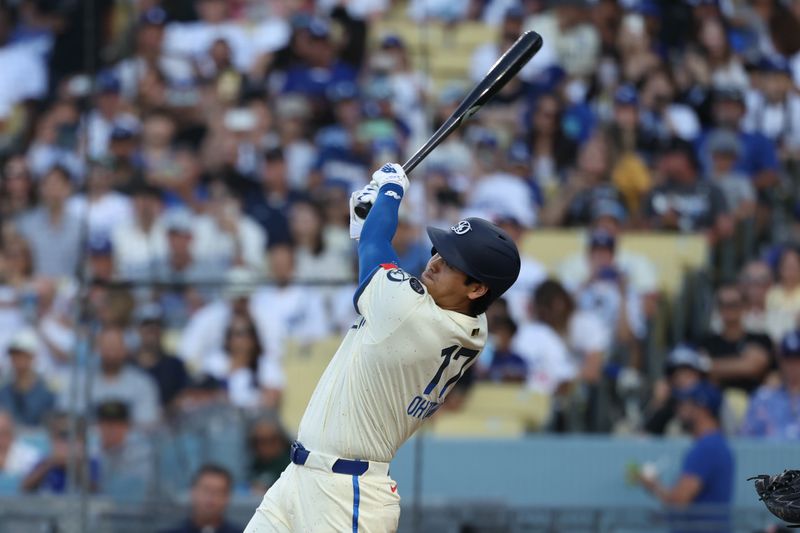 Aug 9, 2025; Los Angeles, California, USA; Los Angeles Dodgers two-way player Shohei Ohtani (17) hits a single against the Toronto Blue Jays during the third inning at Dodger Stadium. Mandatory Credit: Kiyoshi Mio-Imagn Images