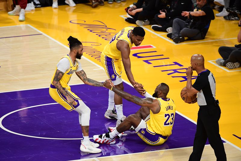 LOS ANGELES, CA - APRIL 25: D'Angelo Russell #1 of the Los Angeles Lakers and Rui Hachimura #28 of the Los Angeles Lakers help up LeBron James #23 of the Los Angeles Lakers during the game against the Denver Nuggets during Round One Game Three of the 2024 NBA Playoffs on April 25, 2024 at Crypto.Com Arena in Los Angeles, California. NOTE TO USER: User expressly acknowledges and agrees that, by downloading and/or using this Photograph, user is consenting to the terms and conditions of the Getty Images License Agreement. Mandatory Copyright Notice: Copyright 2024 NBAE (Photo by Adam Pantozzi/NBAE via Getty Images)