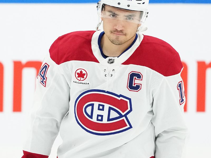 Nov 9, 2024; Toronto, Ontario, CAN;  Montreal Canadiens center Nick Suzuki (14) skates during the warmup before a game against the Toronto Maple Leafs at Scotiabank Arena. Mandatory Credit: Nick Turchiaro-Imagn Images