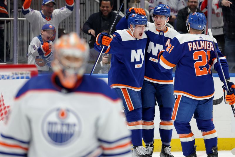 Dec 19, 2023; Elmont, New York, USA; New York Islanders center Bo Horvat (14) celebrates his power play goal against Edmonton Oilers goaltender Stuart Skinner (74) with center Brock Nelson (29) and center Kyle Palmieri (21) during the second period at UBS Arena. Mandatory Credit: Brad Penner-USA TODAY Sports