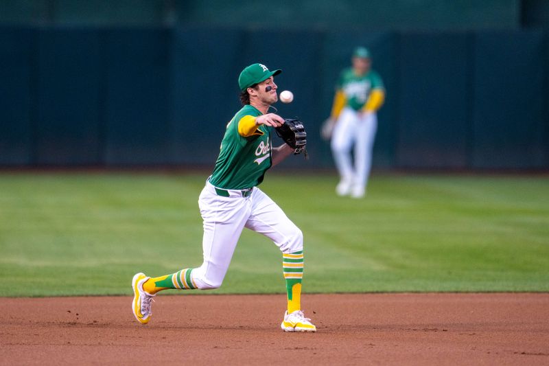 Sep 24, 2024; Oakland, California, USA; Oakland Athletics shortstop Jacob Wilson (5) throws out Texas Rangers second baseman Marcus Semien (2) during the first inning at Oakland-Alameda County Coliseum. Mandatory Credit: Neville E. Guard-Imagn Images