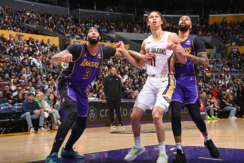 LOS ANGELES, CA - FEBRUARY 9: Anthony Davis #3 of the Los Angeles Lakers, Dyson Daniels #11 of the New Orleans Pelicans, and D'Angelo Russell #1 of the Los Angeles Lakers wait for a rebound during the game on February 9, 2024 at Crypto.Com Arena in Los Angeles, California. NOTE TO USER: User expressly acknowledges and agrees that, by downloading and/or using this Photograph, user is consenting to the terms and conditions of the Getty Images License Agreement. Mandatory Copyright Notice: Copyright 2024 NBAE (Photo by Andrew D. Bernstein/NBAE via Getty Images)