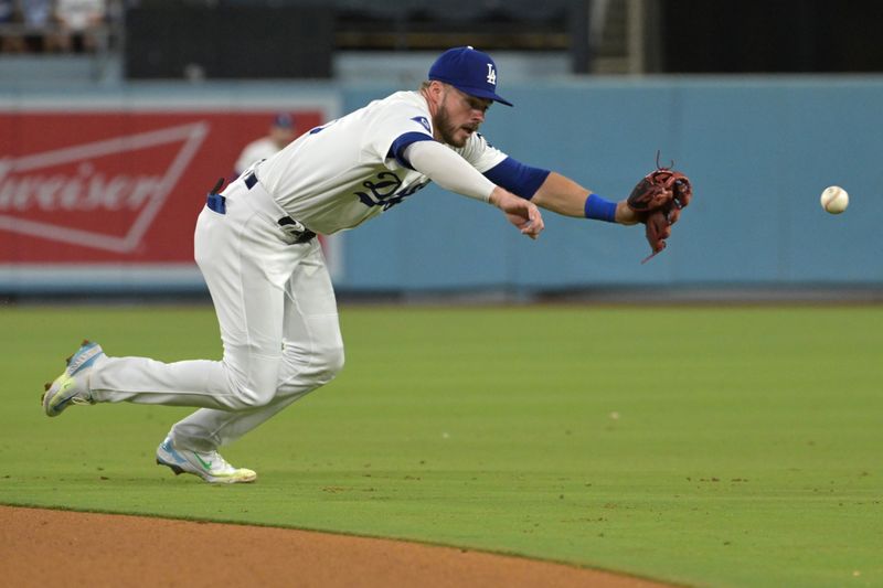 Jul 24, 2024; Los Angeles, California, USA;   San Francisco Giants catcher Patrick Bailey (14) singles past Los Angeles Dodgers second baseman Gavin Lux (9) in the eighth inning at Dodger Stadium. Mandatory Credit: Jayne Kamin-Oncea-USA TODAY Sports