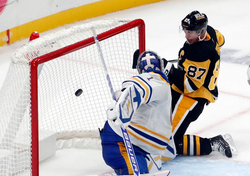 Oct 16, 2024; Pittsburgh, Pennsylvania, USA; Pittsburgh Penguins center Sidney Crosby (87) scores a game winning power play goal against Buffalo Sabres goaltender Ukko-Pekka Luukkonen (1) in overtime at PPG Paints Arena. Mandatory Credit: Charles LeClaire-Imagn Images