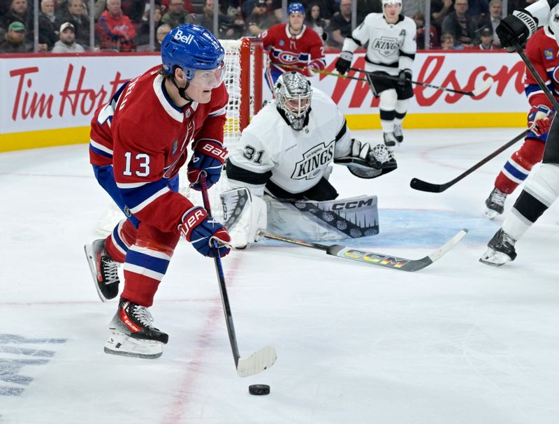 Oct 17, 2024; Montreal, Quebec, CAN; Montreal Canadiens forward Cole Caufield (13) plays the puck and Los Angeles Kings goalie David Rittich (31) defends during the second period at the Bell Centre. Mandatory Credit: Eric Bolte-Imagn Images