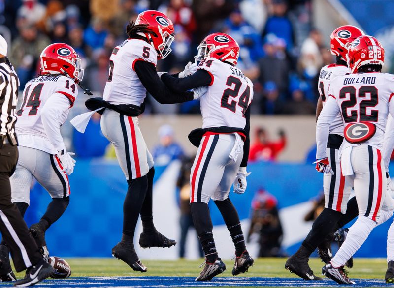 Nov 19, 2022; Lexington, Kentucky, USA; Georgia Bulldogs defensive back Kelee Ringo (5) and defensive back Malaki Starks (24) celebrate during the second quarter against the Kentucky Wildcats at Kroger Field. Mandatory Credit: Jordan Prather-USA TODAY Sports