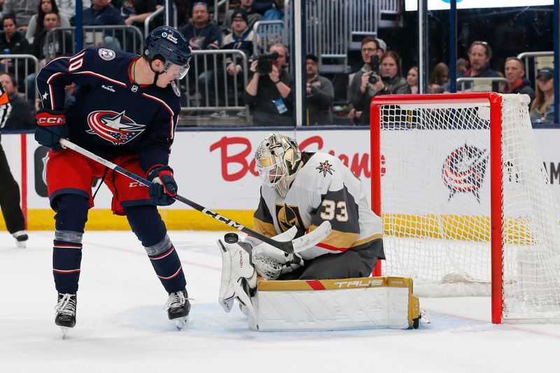 Mar 4, 2024; Columbus, Ohio, USA; Vegas Golden Knights goalie Adin Hill (33) makes a save on the tip from Columbus Blue Jackets left wing Dmitri Voronkov (10) during the second period at Nationwide Arena. Mandatory Credit: Russell LaBounty-USA TODAY Sports