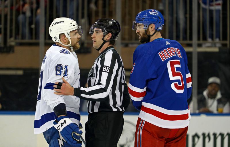 Apr 5, 2023; New York, New York, USA; New York Rangers defenseman Ben Harpur (5) and Tampa Bay Lightning defenseman Erik Cernak (81) are separated by linesman Jesse Marquis (86) during the second period at Madison Square Garden. Mandatory Credit: Danny Wild-USA TODAY Sports