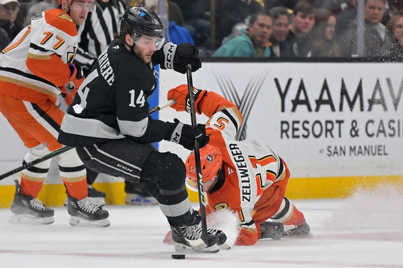 Dec 27, 2025; Los Angeles, California, USA;  Los Angeles Kings right wing Alex Laferriere (14) takes the puck from Anaheim Ducks defenseman Olen Zellweger (51) during the second period at Crypto.com Arena. Mandatory Credit: Jayne Kamin-Oncea-Imagn Images