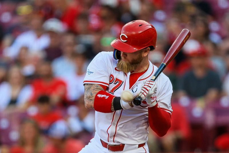 May 21, 2024; Cincinnati, Ohio, USA; Cincinnati Reds outfielder Jake Fraley (27) gets hit by a wild pitch in the first inning against the San Diego Padres at Great American Ball Park. Mandatory Credit: Katie Stratman-USA TODAY Sports