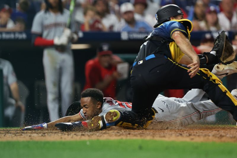 Aug 16, 2024; Philadelphia, Pennsylvania, USA; Washington Nationals shortstop Nasim Nunez (26) slides past Philadelphia Phillies catcher J.T. Realmuto (10) for a run during the ninth inning at Citizens Bank Park. Mandatory Credit: Bill Streicher-USA TODAY Sports