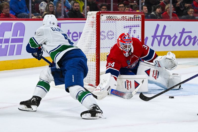 Nov 12, 2023; Montreal, Quebec, CAN; Montreal Canadiens goalie Jake Allen (34) makes a save against Vancouver Canucks right wing Conor Garland (8) during the first period at Bell Centre. Mandatory Credit: David Kirouac-USA TODAY Sports