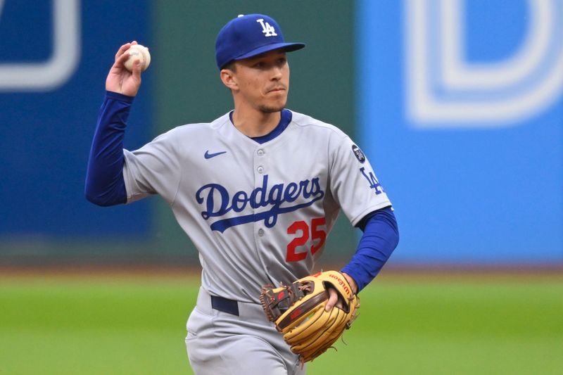 May 27, 2025; Cleveland, Ohio, USA; Los Angeles Dodgers second baseman Tommy Edman (25) throws to first base in the third inning against the Cleveland Guardians at Progressive Field. Mandatory Credit: David Richard-Imagn Images