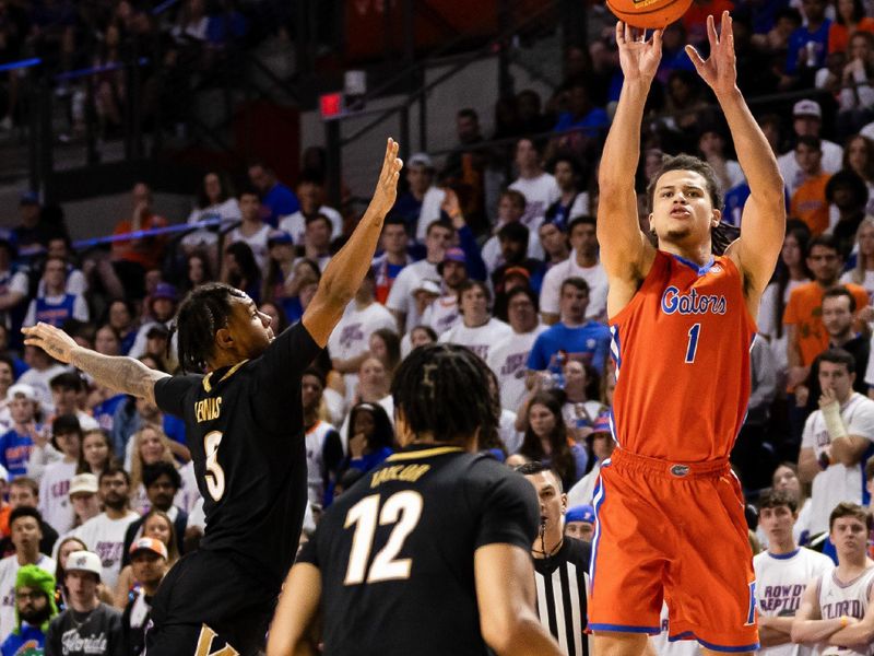 Feb 24, 2024; Gainesville, Florida, USA; Florida Gators guard Walter Clayton Jr. (1) shoots a three-point shot over Vanderbilt Commodores guard Ezra Manjon (5) during the second half at Exactech Arena at the Stephen C. O'Connell Center. Mandatory Credit: Matt Pendleton-USA TODAY Sports