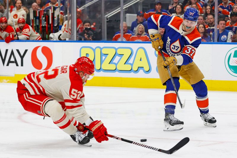 Feb 24, 2024; Edmonton, Alberta, CAN; Edmonton Oilers forward Warren Foegele (37) tries to make a pass in front of Calgary Flames defensemen MacKenzie Weager (52) during the first period at Rogers Place. Mandatory Credit: Perry Nelson-USA TODAY Sports