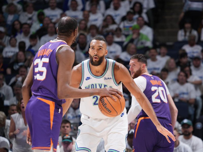 MINNEAPOLIS, MN -  APRIL 20: Kevin Durant #35 of the Phoenix Suns handles the ball while Rudy Gobert #27 of the Minnesota Timberwolves plays defense during Round One Game One of the 2024 NBA Playoffs on April 20, 2024 at Target Center in Minneapolis, Minnesota. NOTE TO USER: User expressly acknowledges and agrees that, by downloading and or using this Photograph, user is consenting to the terms and conditions of the Getty Images License Agreement. Mandatory Copyright Notice: Copyright 2024 NBAE (Photo by Jordan Johnson/NBAE via Getty Images)