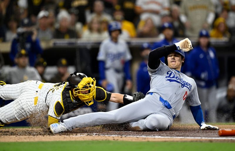 Oct 9, 2024; San Diego, California, USA; San Diego Padres catcher Kyle Higashioka (20) tags out Los Angeles Dodgers designated hitter Shohei Ohtani (17) at home in the fourth inning during game four of the NLDS for the 2024 MLB Playoffs at Petco Park.  Mandatory Credit: Denis Poroy-Imagn Images