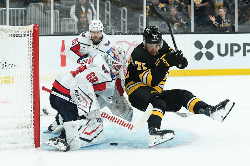 Sep 21, 2025; Boston, Massachusetts, USA; Boston Bruins left wing Viktor Arvidsson (71) crashes into Washington Capitals goaltender Garin Bjorklund (68) during the third period at TD Garden. Mandatory Credit: Bob DeChiara-Imagn Images