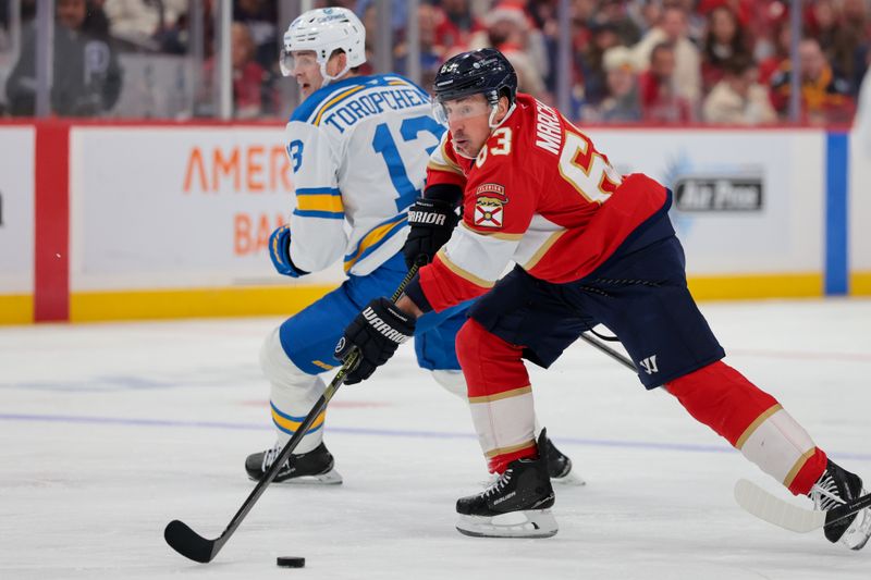 Dec 20, 2025; Sunrise, Florida, USA; Florida Panthers left wing Brad Marchand (63) moves the puck against St. Louis Blues right wing Alexey Toropchenko (13) during the second period at Amerant Bank Arena. Mandatory Credit: Sam Navarro-Imagn Images