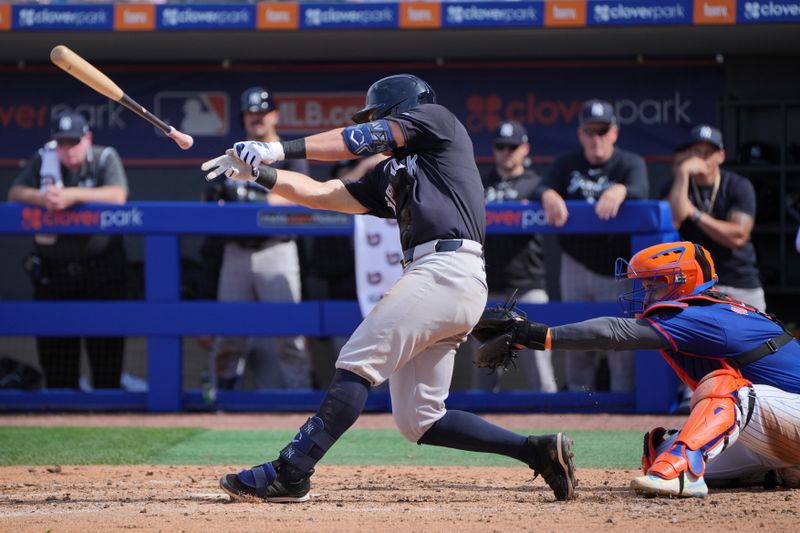 Mar 5, 2024; Port St. Lucie, Florida, USA;  New York Yankees shortstop Anthony Volpe (11) loses his bat in the fifth inning against the New York Mets at Clover Park. The bat landed in the third base photo well.  Mandatory Credit: Jim Rassol-USA TODAY Sports