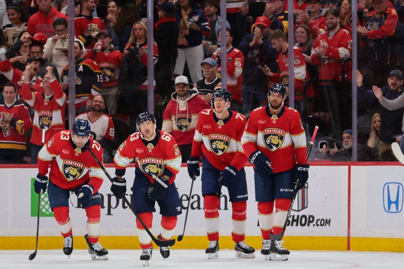 Nov 26, 2025; Sunrise, Florida, USA; Florida Panthers left wing Brad Marchand (63) celebrates with center Carter Verhaeghe (23), defenseman Niko Mikkola (77) and defenseman Seth Jones (3) after scoring against the Philadelphia Flyers during the first period at Amerant Bank Arena. Mandatory Credit: Sam Navarro-Imagn Images