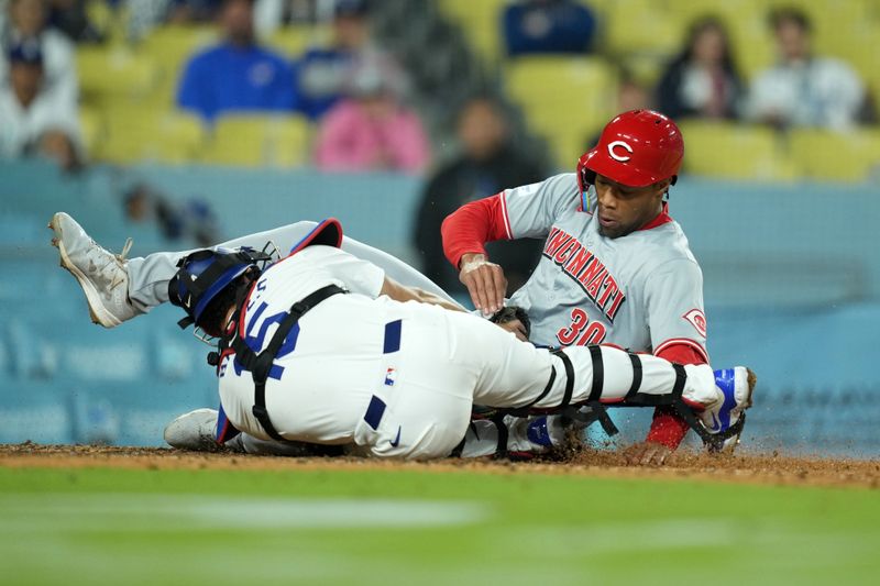 May 16, 2024; Los Angeles, California, USA; Los Angeles Dodgers catcher Austin Barnes (15) tags out Cincinnati Reds center fielder Will Benson (30) out at home plate in the ninth inning at Dodger Stadium. Mandatory Credit: Kirby Lee-USA TODAY Sports