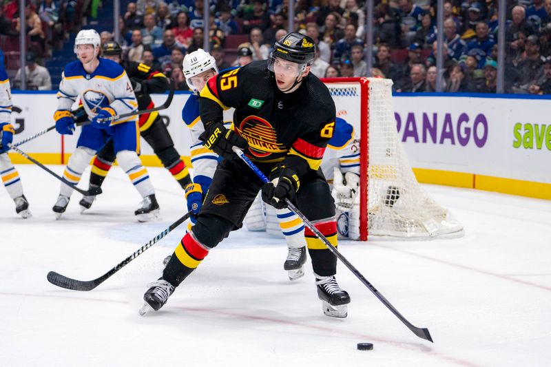 Mar 19, 2024; Vancouver, British Columbia, CAN; Vancouver Canucks forward Ilya Mikheyev (65) handles the puck against the Buffalo Sabres in the third period at Rogers Arena. Vancouver won 3 -2. Mandatory Credit: Bob Frid-USA TODAY Sports