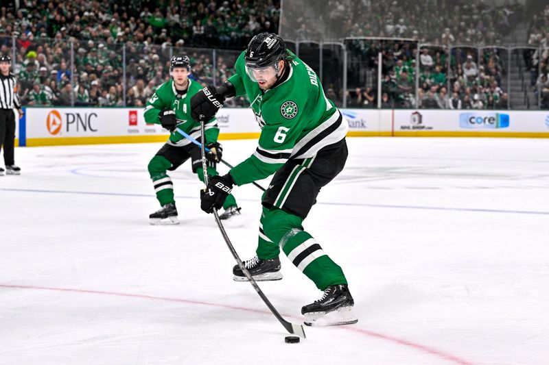 Dec 14, 2024; Dallas, Texas, USA; Dallas Stars defenseman Lian Bichsel (6) attempts a shot in the St. Louis Blues zone during the second period at American Airlines Center. Mandatory Credit: Jerome Miron-Imagn Images