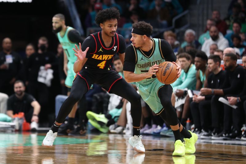 CHARLOTTE, NC - NOVEMBER 30: Kobe Bufkin #4 of the Atlanta Hawks plays defense during the game against the Charlotte Hornets on November 30, 2024 at Spectrum Center in Charlotte, North Carolina. NOTE TO USER: User expressly acknowledges and agrees that, by downloading and or using this photograph, User is consenting to the terms and conditions of the Getty Images License Agreement. Mandatory Copyright Notice: Copyright 2024 NBAE (Photo by Brock Williams-Smith/NBAE via Getty Images)