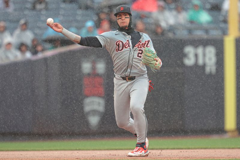 May 5, 2024; Bronx, New York, USA; Detroit Tigers shortstop Javier Baez (28) throws the ball to first base for an out during the fifth inning against the New York Yankees at Yankee Stadium. Mandatory Credit: Vincent Carchietta-USA TODAY Sports