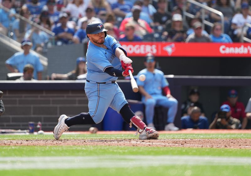 Aug 25, 2024; Toronto, Ontario, CAN; Toronto Blue Jays catcher Alejandro Kirk (30) hits a two run home run against the Los Angeles Angels during the seventh inning at Rogers Centre. Mandatory Credit: Nick Turchiaro-USA TODAY Sports