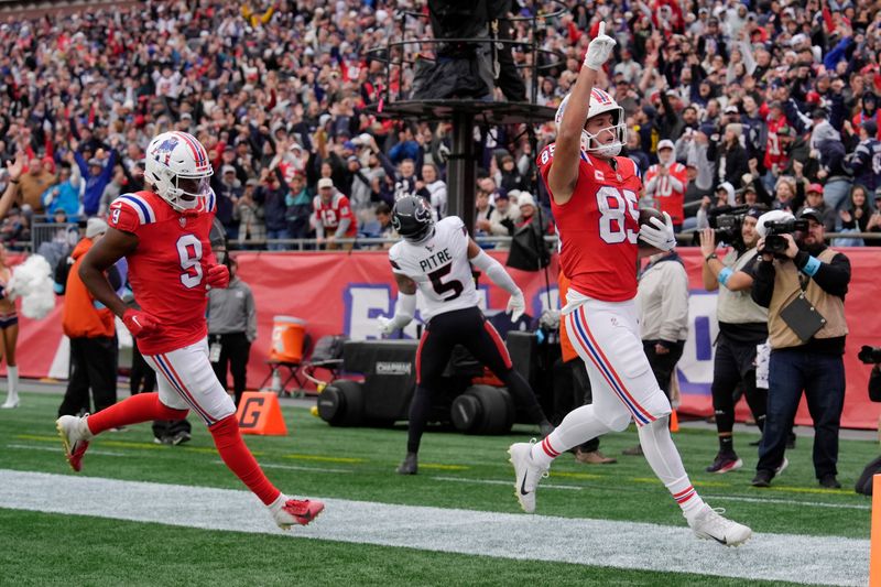 New England Patriots tight end Hunter Henry (85) celebrates after his touchdown in front of Patriots wide receiver Kayshon Boutte (9) during the second half of an NFL football game against the Houston Texans, Sunday, Oct. 13, 2024, in Foxborough, Mass. (AP Photo/Steven Senne)