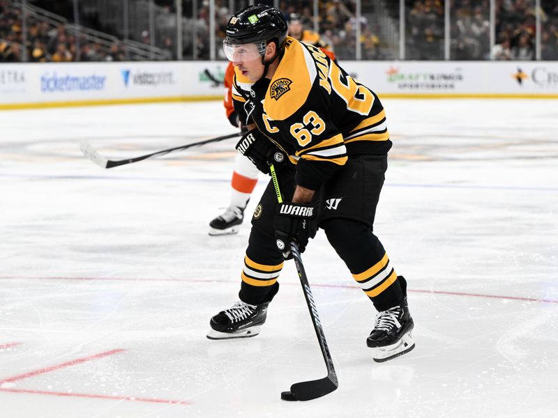 Oct 29, 2024; Boston, Massachusetts, USA; Boston Bruins left wing Brad Marchand (63) skates with the puck against the Philadelphia Flyers during the third period at TD Garden. Mandatory Credit: Brian Fluharty-Imagn Images