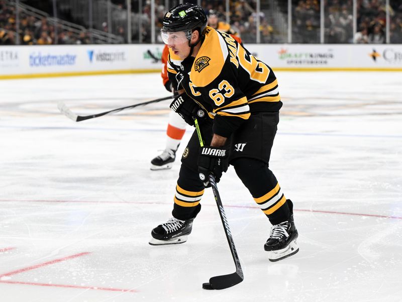 Oct 29, 2024; Boston, Massachusetts, USA; Boston Bruins left wing Brad Marchand (63) skates with the puck against the Philadelphia Flyers during the third period at TD Garden. Mandatory Credit: Brian Fluharty-Imagn Images