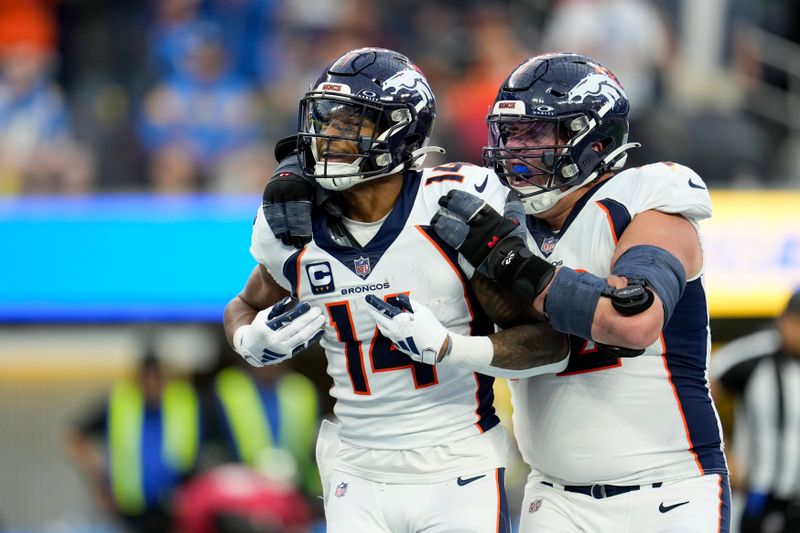 Denver Broncos wide receiver Courtland Sutton (14) celebrates his touchdown with offensive tackle Garett Bolles during the second half of an NFL football game against the Los Angeles Chargers Sunday, Dec. 10, 2023, in Inglewood, Calif. (AP Photo/Marcio Jose Sanchez)