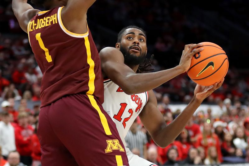 Dec 3, 2023; Columbus, Ohio, USA;  Ohio State Buckeyes guard Evan Mahaffey (12) looks for an opening to shoot as Minnesota Golden Gophers forward Joshua Ola-Joseph (1) defends him on the play during the second half at Value City Arena. Mandatory Credit: Joseph Maiorana-USA TODAY Sports