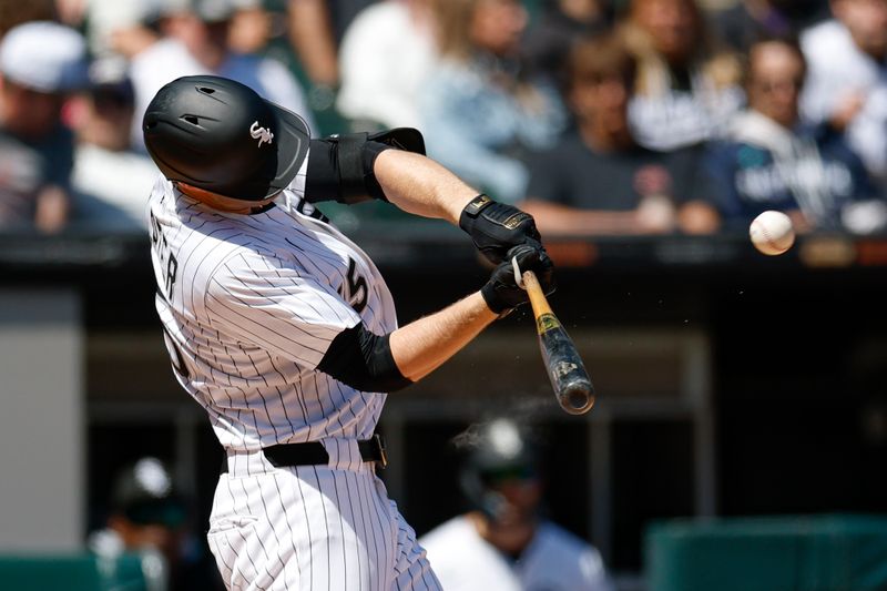 May 25, 2025; Chicago, Illinois, USA; Chicago White Sox left fielder Austin Slater (15) hits a solo home run against the Texas Rangers during the sixth inning at Rate Field. Mandatory Credit: Kamil Krzaczynski-Imagn Images