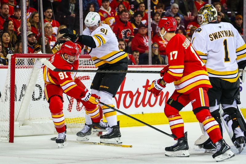 Dec 29, 2025; Calgary, Alberta, CAN; Calgary Flames center Nazem Kadri (91) and Boston Bruins defenseman Nikita Zadorov (91) get into a scrum during the second period at Scotiabank Saddledome. Mandatory Credit: Sergei Belski-Imagn Images