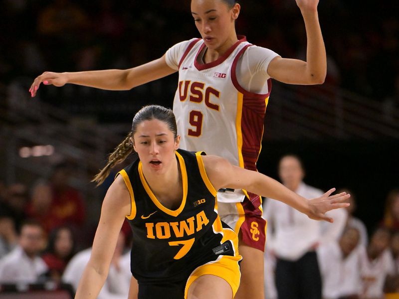 Jan 29, 2026; Los Angeles, California, USA; Iowa Hawkeyes guard Addie Deal (7) drives past USC Trojans guard Jazzy Davidson (9) in the second half at Galen Center. Mandatory Credit: Jayne Kamin-Oncea-Imagn Images