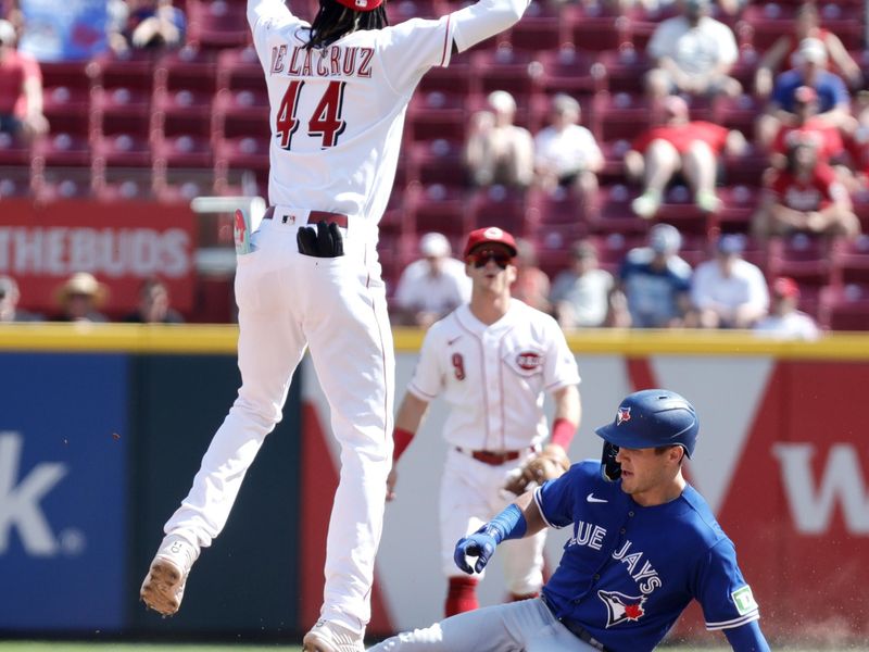 Aug 20, 2023; Cincinnati, Ohio, USA; Toronto Blue Jays left fielder Daulton Varsho (25) is safe at second for a double against Cincinnati Reds third baseman Elly De La Cruz (44) during the ninth inning at Great American Ball Park. Mandatory Credit: David Kohl-USA TODAY Sports