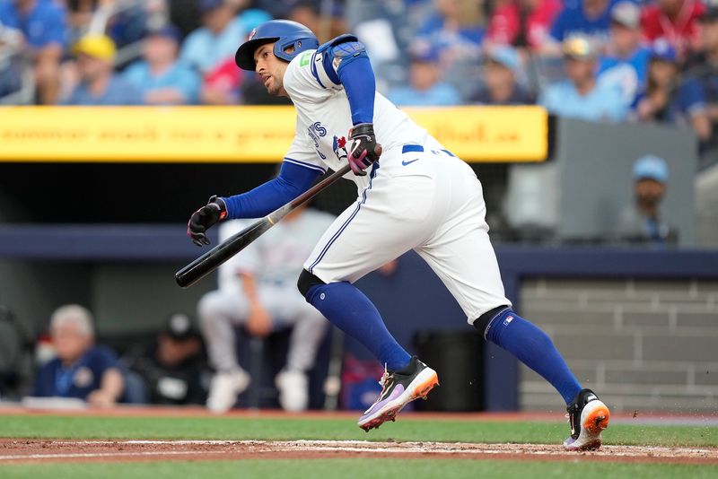 Jul 26, 2024; Toronto, Ontario, CAN; Toronto Blue Jays right fielder George Springer (4) hits a single against the Texas Rangers during the first inning at Rogers Centre. Mandatory Credit: John E. Sokolowski-USA TODAY Sports