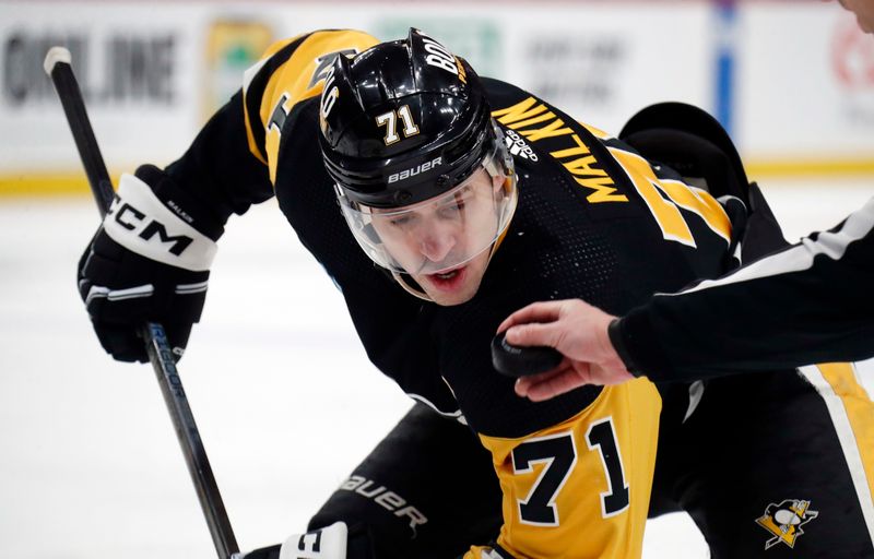 Apr 6, 2024; Pittsburgh, Pennsylvania, USA;  Pittsburgh Penguins center Evgeni Malkin (71) watches the puck on a face-off against the Tampa Bay Lightning during the first period at PPG Paints Arena. Mandatory Credit: Charles LeClaire-USA TODAY Sports