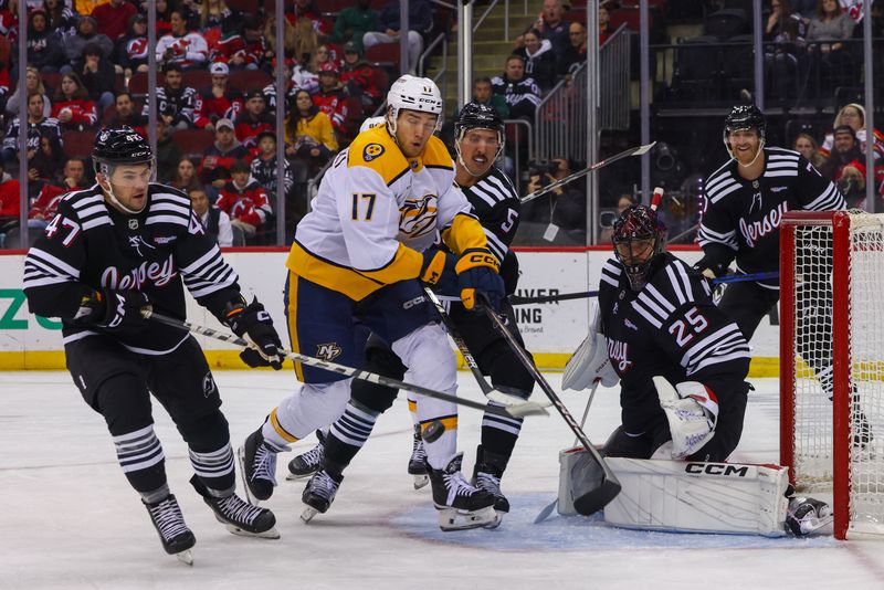 Nov 25, 2024; Newark, New Jersey, USA; Nashville Predators center Mark Jankowski (17) and New Jersey Devils defenseman Brenden Dillon (5) battle for the puck in front of New Jersey Devils goaltender Jacob Markstrom (25) during the first period at Prudential Center. Mandatory Credit: Ed Mulholland-Imagn Images